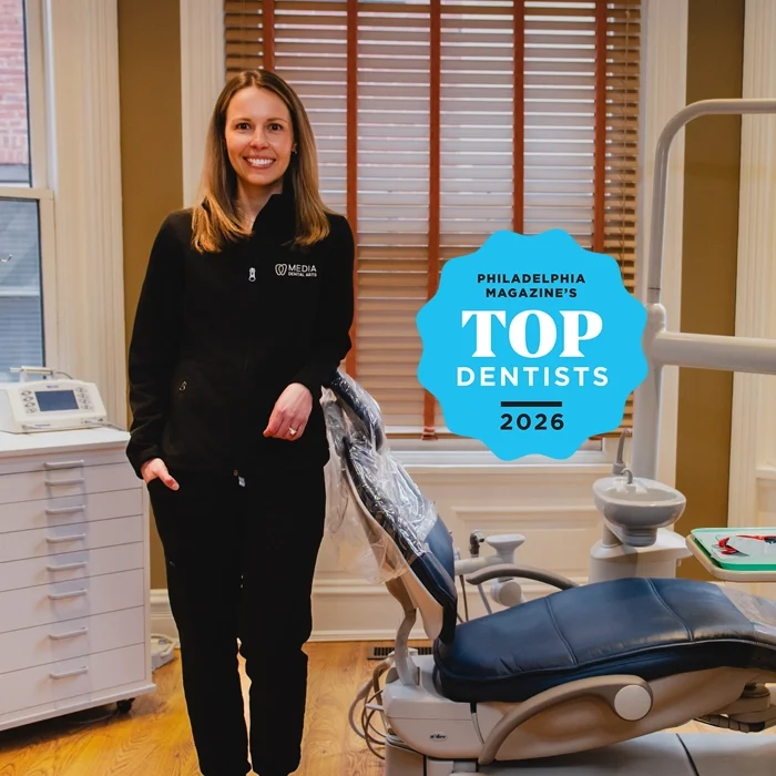 Dr. Alice Bassani posing with a dental exam chair